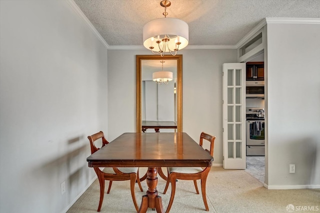 dining space with a textured ceiling, ornamental molding, light carpet, and a chandelier