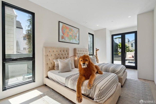 bedroom featuring french doors, access to outside, and multiple windows