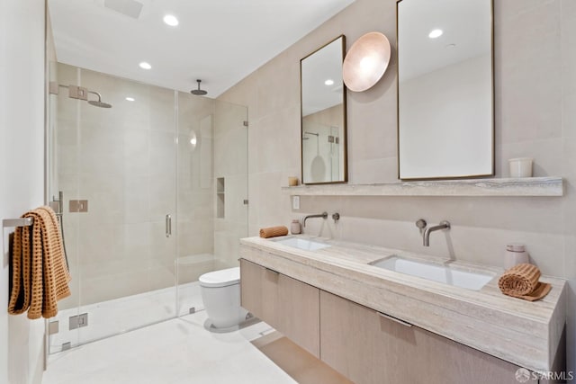 bathroom featuring tile patterned flooring, toilet, an enclosed shower, and vanity