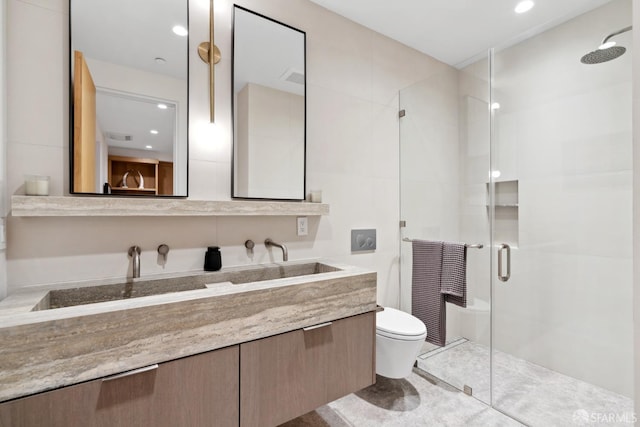 bathroom with tile patterned flooring, vanity, toilet, and an enclosed shower