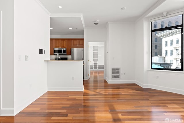 interior space with crown molding and hardwood / wood-style flooring