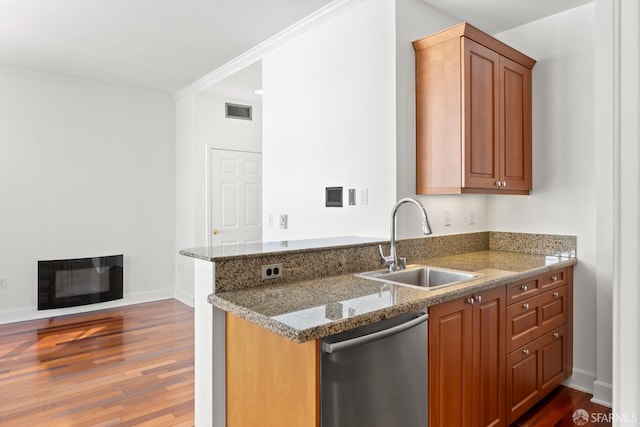 kitchen featuring sink, ornamental molding, dark hardwood / wood-style flooring, dishwasher, and stone counters