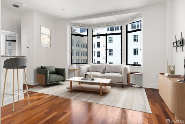 living room with hardwood / wood-style floors and crown molding