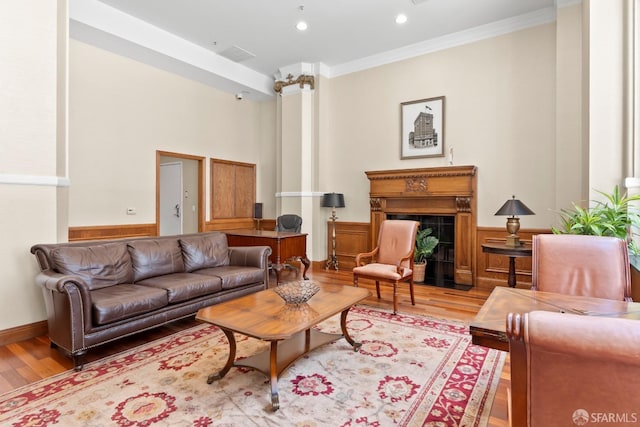 living room featuring wood-type flooring and ornamental molding