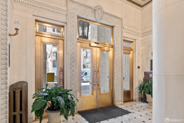 view of exterior entry with radiator heating unit and french doors