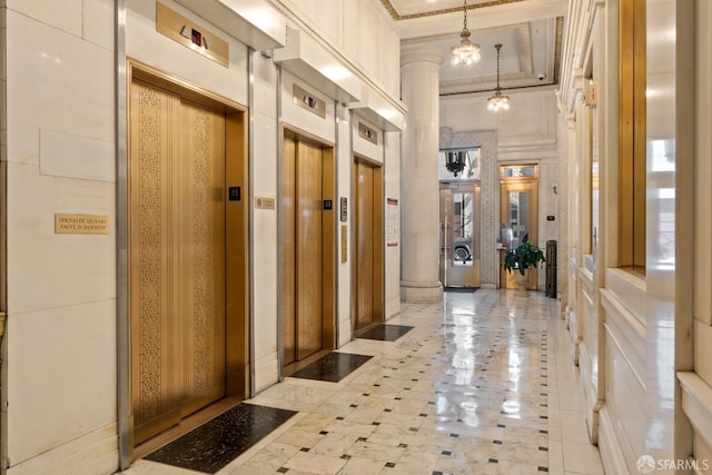 mudroom featuring crown molding, a towering ceiling, and elevator