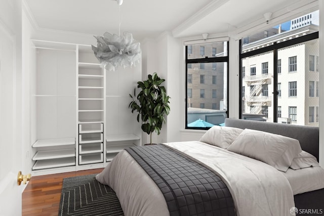 bedroom featuring hardwood / wood-style flooring and crown molding