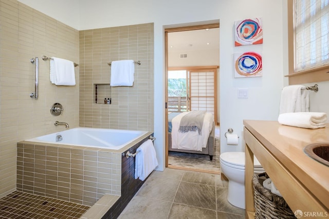 bathroom with toilet, tiled bath, tile patterned floors, and vanity