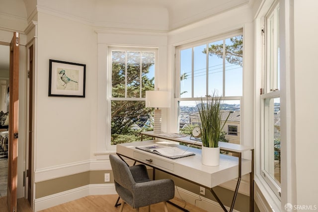 home office with light hardwood / wood-style floors and crown molding