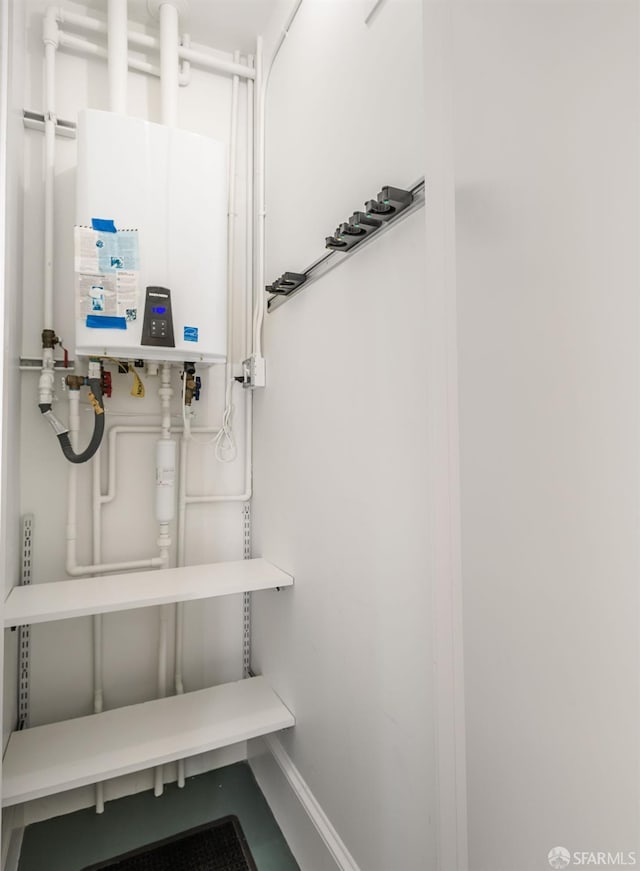 utility room featuring tankless water heater