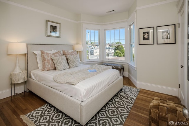 bedroom with dark hardwood / wood-style flooring