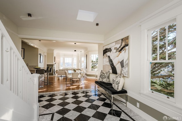 interior space with a skylight and tile patterned floors