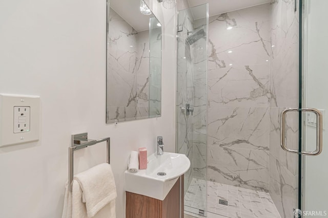 bathroom with vanity and a marble finish shower