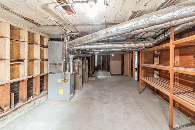 unfinished basement featuring heating unit