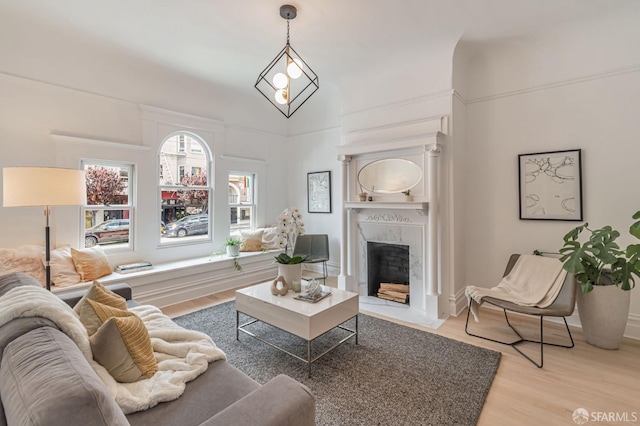 living room with light wood finished floors, baseboards, and a fireplace
