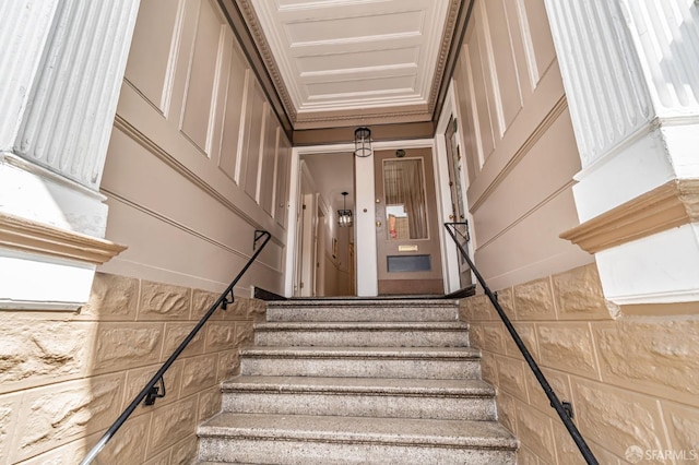 staircase featuring ornamental molding