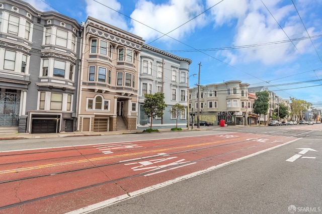 view of street with sidewalks, street lights, and curbs