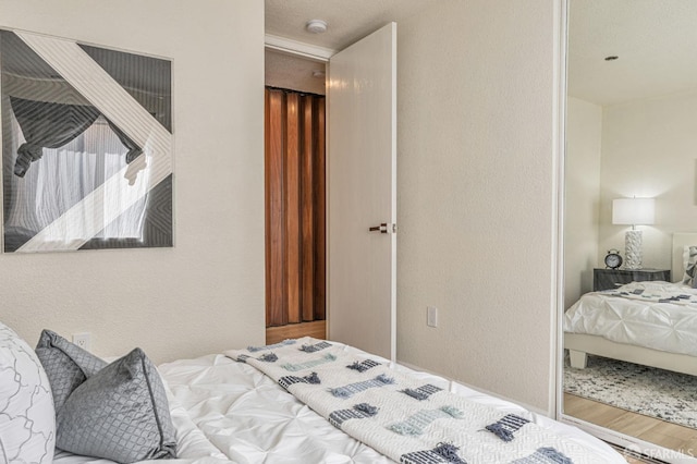 1396 El Camino Real Unit 110, Millbrae, CA 94030 - bedroom with a textured wall and wood finished floors