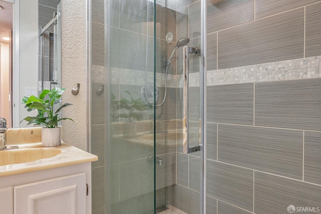 1396 El Camino Real Unit 110, Millbrae, CA 94030 - full bath featuring vanity, a stall shower, and a textured wall