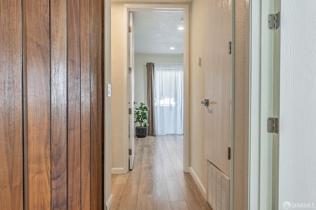1396 El Camino Real Unit 110, Millbrae, CA 94030 - hallway featuring light wood-style floors and a textured ceiling