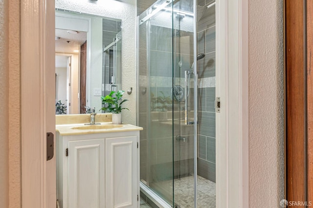 1396 El Camino Real Unit 110, Millbrae, CA 94030 - bathroom with a textured wall, a shower stall, and vanity