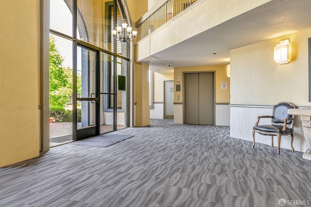 1396 El Camino Real Unit 110, Millbrae, CA 94030 - common area featuring a textured wall, a high ceiling, and a wainscoted wall