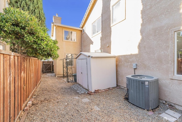 view of side of property with a storage unit and central AC unit