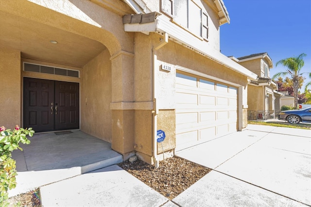 doorway to property with a garage