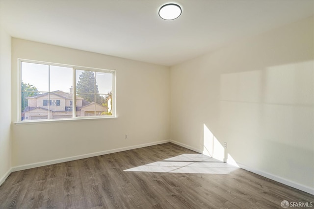 unfurnished room with hardwood / wood-style floors