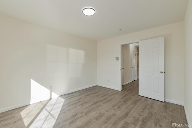 unfurnished room with light hardwood / wood-style flooring