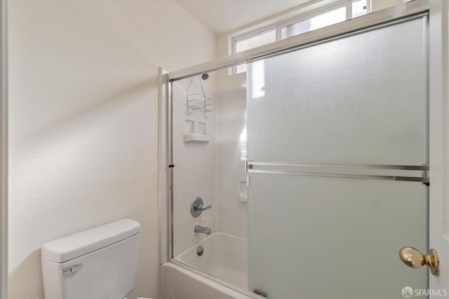 bathroom with enclosed tub / shower combo and toilet