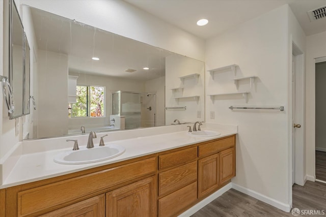 bathroom featuring vanity, plus walk in shower, and wood-type flooring