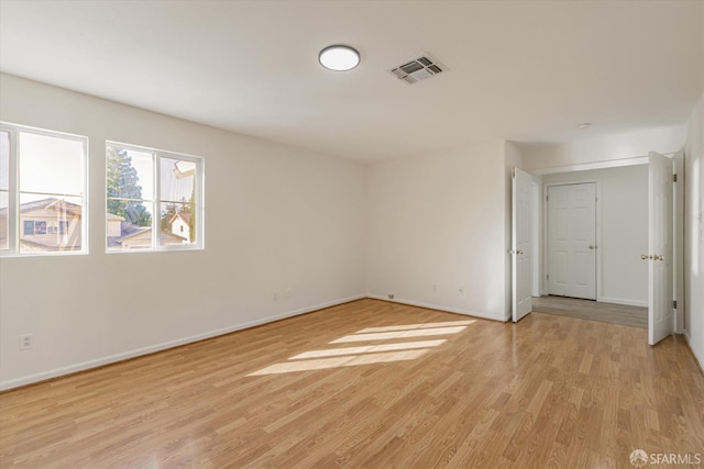 empty room with light hardwood / wood-style floors