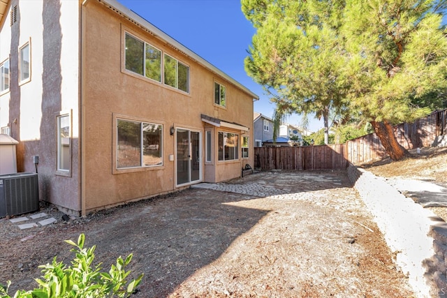 rear view of property featuring cooling unit and a patio area