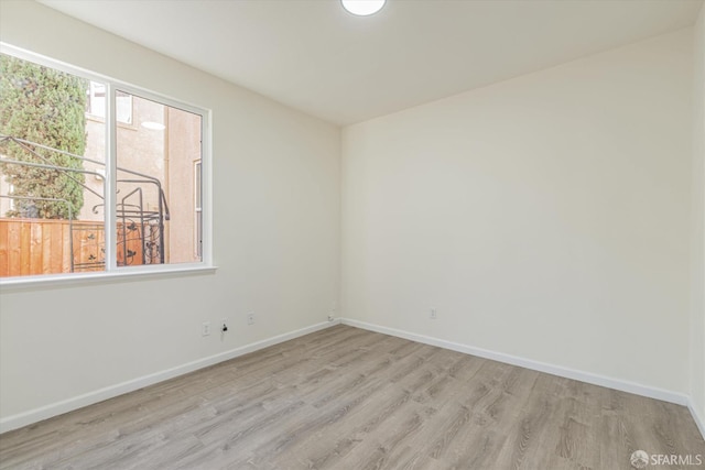 spare room with light hardwood / wood-style floors