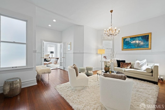 living room featuring baseboards, recessed lighting, dark wood-style flooring, and a chandelier