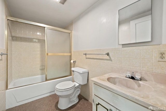 full bathroom with toilet, vanity, tile walls, tile patterned flooring, and enclosed tub / shower combo