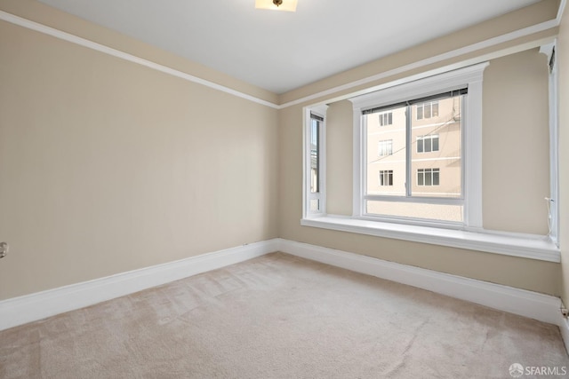 spare room featuring light colored carpet