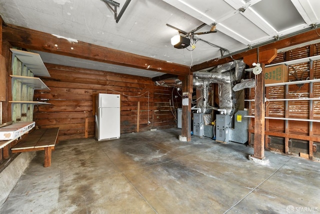 garage with white fridge and a garage door opener