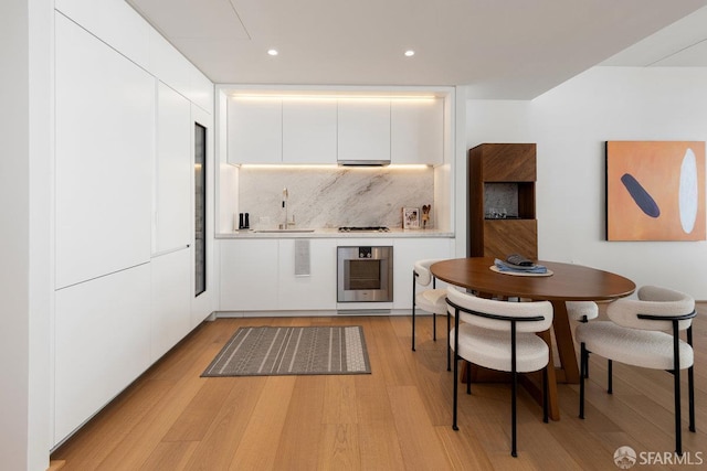 1 Steuart Ln Unit 608, San Francisco, CA 94105 - kitchen featuring a sink, white cabinetry, light wood finished floors, modern cabinets, and recessed lighting