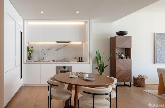 dining space with light wood-type flooring and recessed lighting