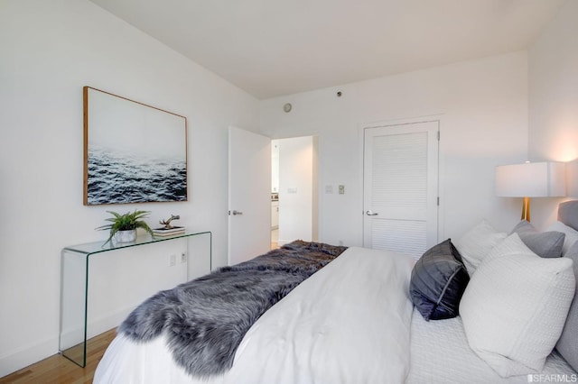 bedroom featuring light wood-type flooring and a closet