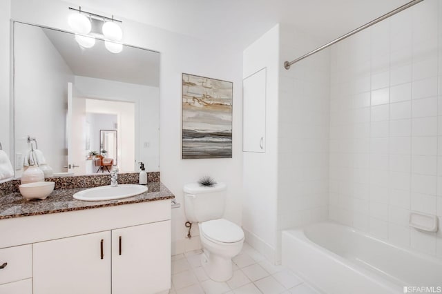 full bathroom with tile patterned floors, vanity, tiled shower / bath combo, and toilet