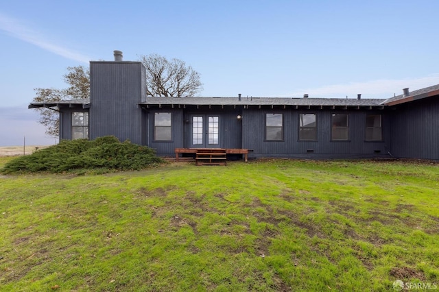 rear view of property featuring french doors and a yard