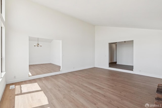 4411 Camino Vaqueros, Brentwood, CA 94513 - unfurnished room with a chandelier, wood finished floors, and high vaulted ceiling