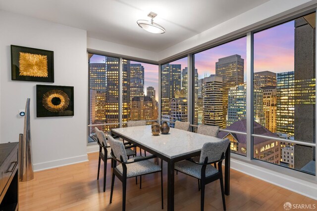 188 Minna St Unit 24A, San Francisco, CA 94105 - dining room with a skyline view, wood finished floors, and baseboards
