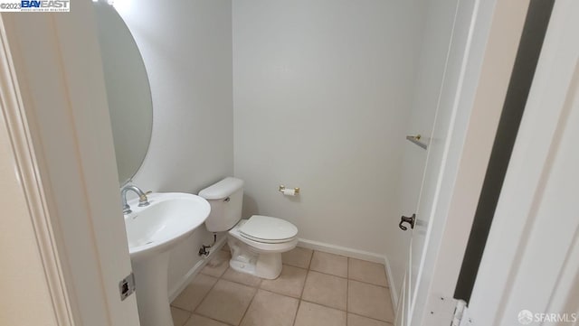 bathroom with tile patterned flooring and toilet