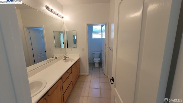 bathroom featuring tile patterned floors, vanity, and toilet