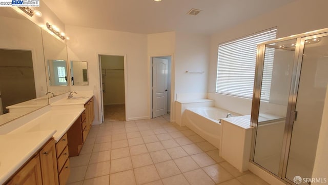 bathroom featuring tile patterned floors, separate shower and tub, and vanity