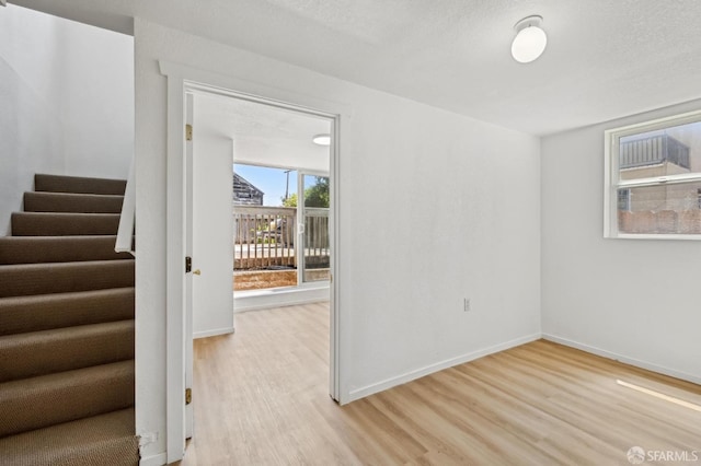 77 Reddy St, San Francisco, CA 94124 - spare room featuring light wood-style floors, stairs, and baseboards